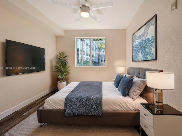 bedroom with wood finished floors, baseboards, and ceiling fan