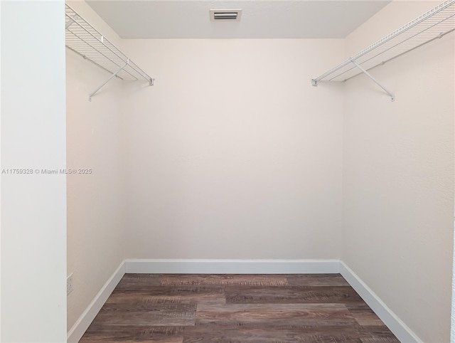 walk in closet featuring wood finished floors and visible vents