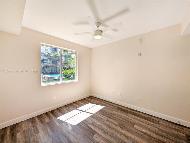 spare room with a ceiling fan, wood finished floors, and baseboards