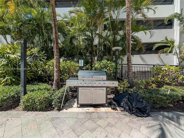 view of patio / terrace featuring grilling area and fence