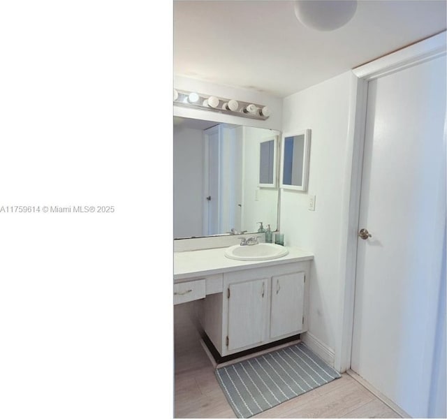 bathroom featuring vanity and wood finished floors