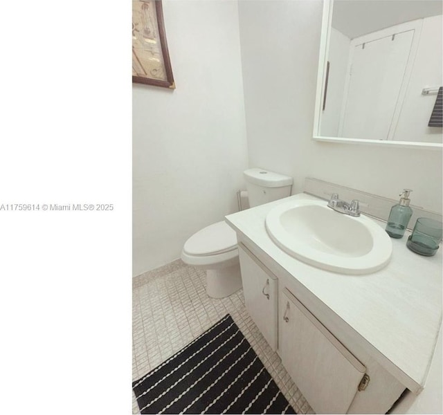 bathroom with vanity, toilet, and tile patterned flooring