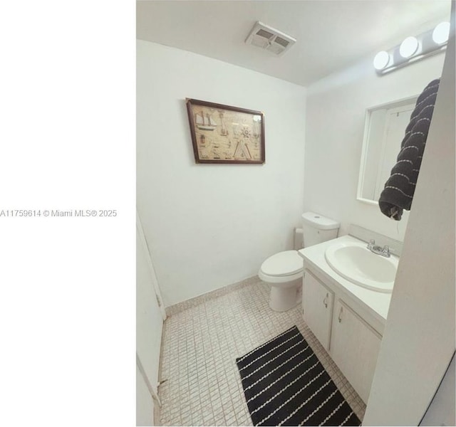 bathroom with vanity, tile patterned floors, toilet, and visible vents