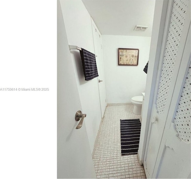 bathroom with tile patterned floors, toilet, and visible vents