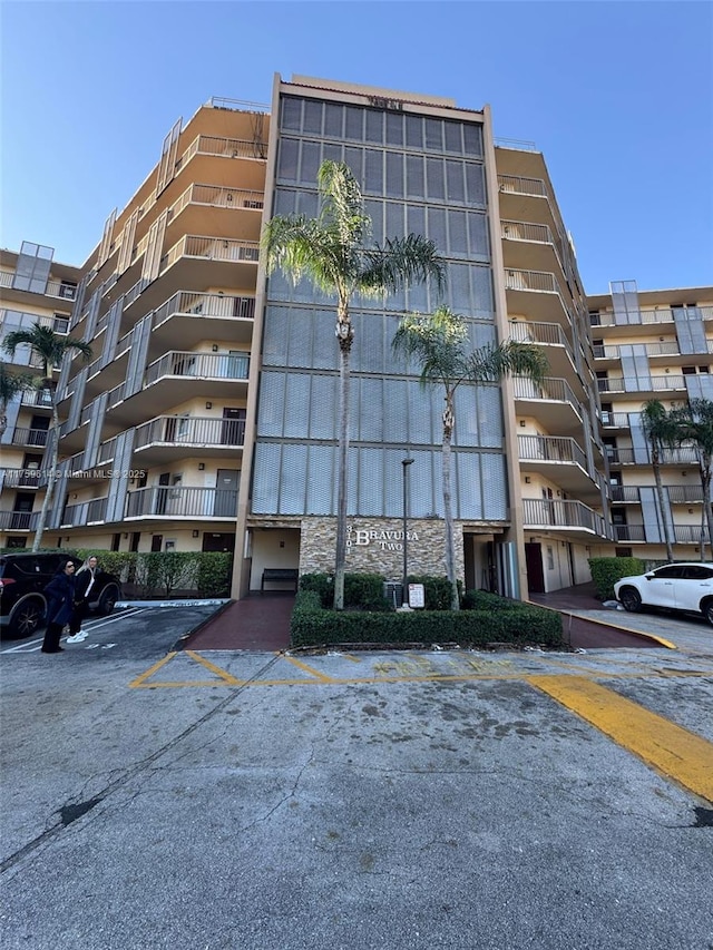 view of building exterior featuring uncovered parking