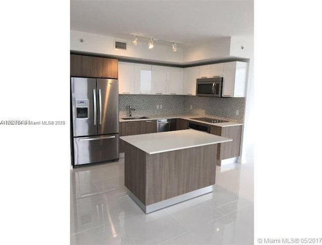 kitchen featuring visible vents, modern cabinets, tasteful backsplash, appliances with stainless steel finishes, and white cabinets