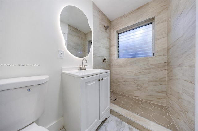 bathroom with tiled shower, marble finish floor, vanity, and toilet