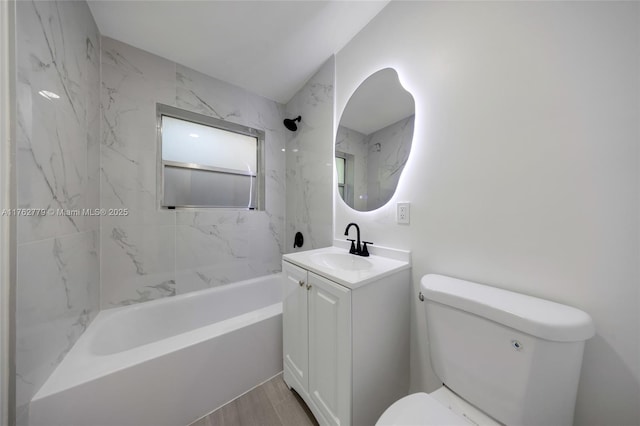 full bathroom featuring vanity, wood finished floors, toilet, and tub / shower combination