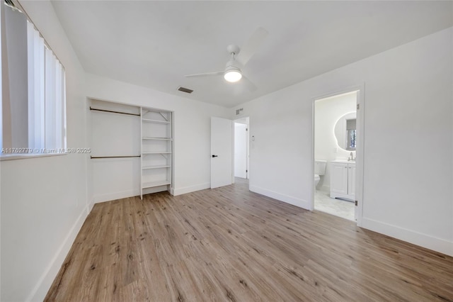 unfurnished bedroom with a ceiling fan, baseboards, visible vents, a closet, and light wood-type flooring