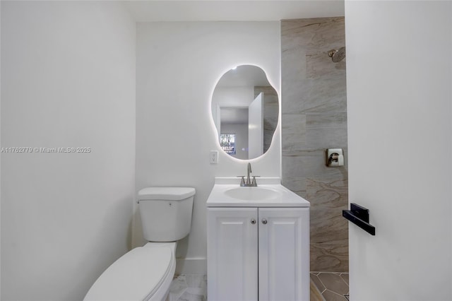 bathroom featuring toilet and vanity