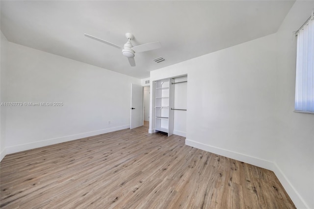 unfurnished bedroom featuring light wood-type flooring, visible vents, baseboards, and a ceiling fan