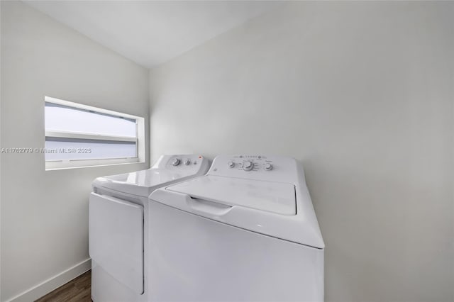 washroom featuring laundry area, baseboards, dark wood-style flooring, and washer and clothes dryer