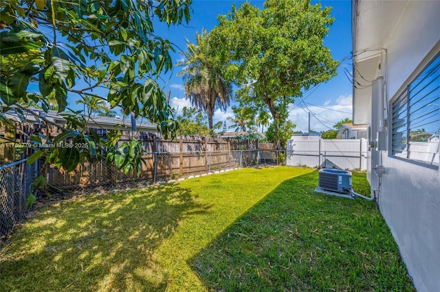 view of yard with cooling unit and a fenced backyard