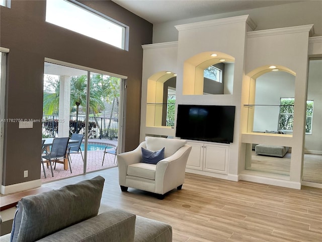 living area with a high ceiling and light wood finished floors