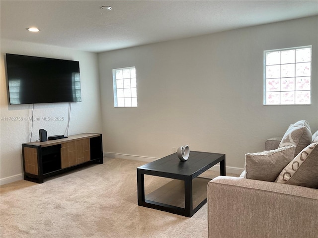 living area with recessed lighting, baseboards, and light carpet