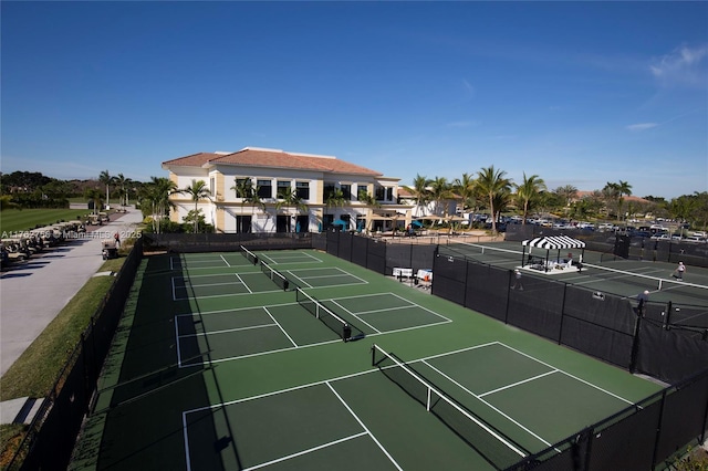 view of tennis court featuring fence