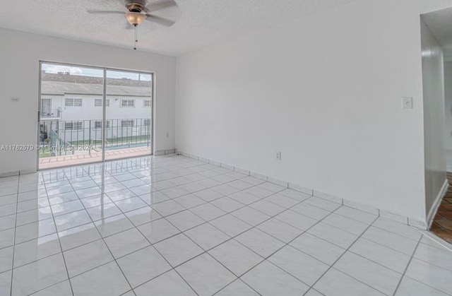 unfurnished room featuring ceiling fan, a textured ceiling, and light tile patterned flooring