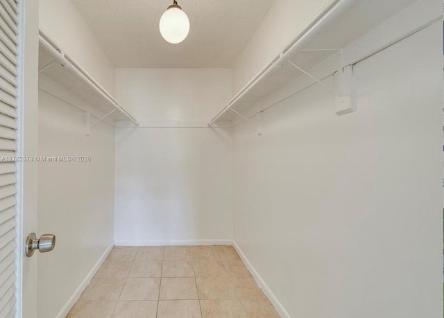 walk in closet featuring light tile patterned floors