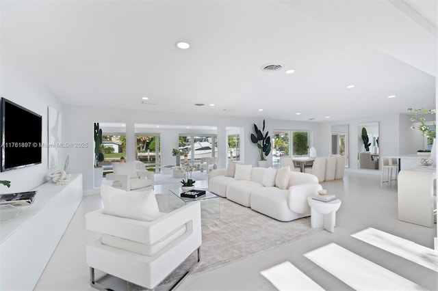 living area featuring recessed lighting and visible vents