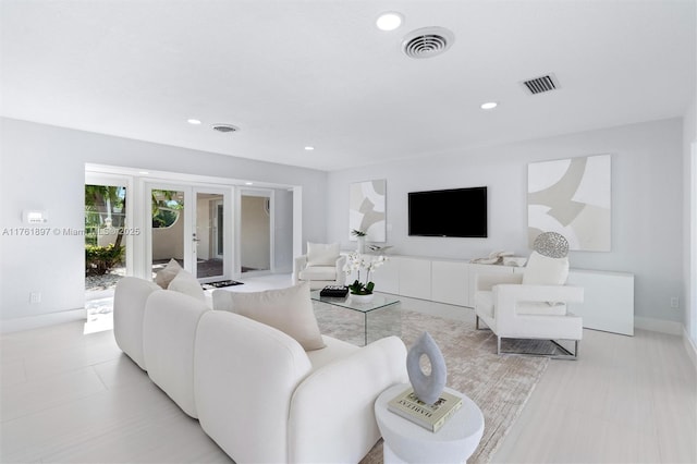 living room featuring recessed lighting, french doors, and visible vents