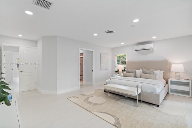 bedroom with a wall mounted air conditioner, visible vents, and recessed lighting