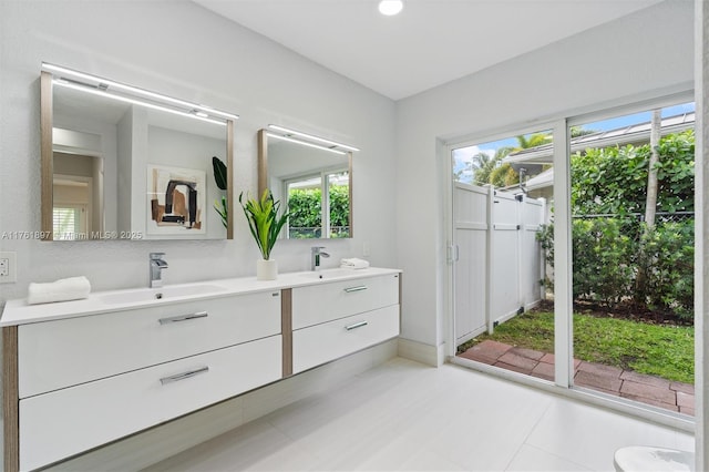 bathroom with a sink and double vanity