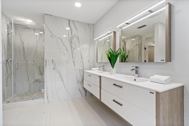 bathroom featuring double vanity, visible vents, a marble finish shower, and a sink