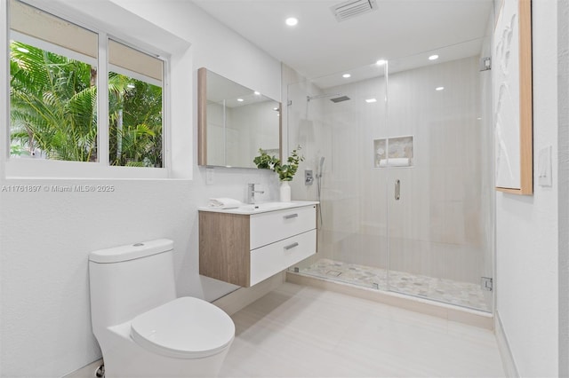 full bathroom featuring visible vents, toilet, a stall shower, and vanity