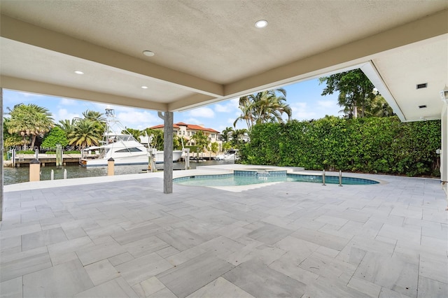 view of pool with a patio area and a pool with connected hot tub