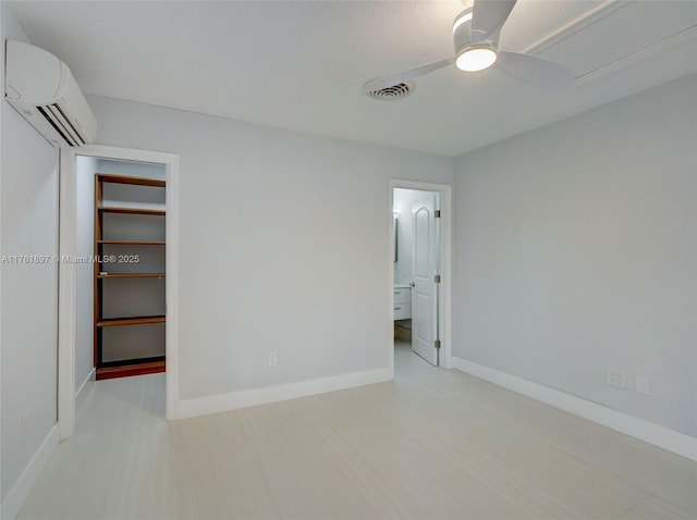 unfurnished bedroom featuring visible vents, ceiling fan, baseboards, an AC wall unit, and a closet