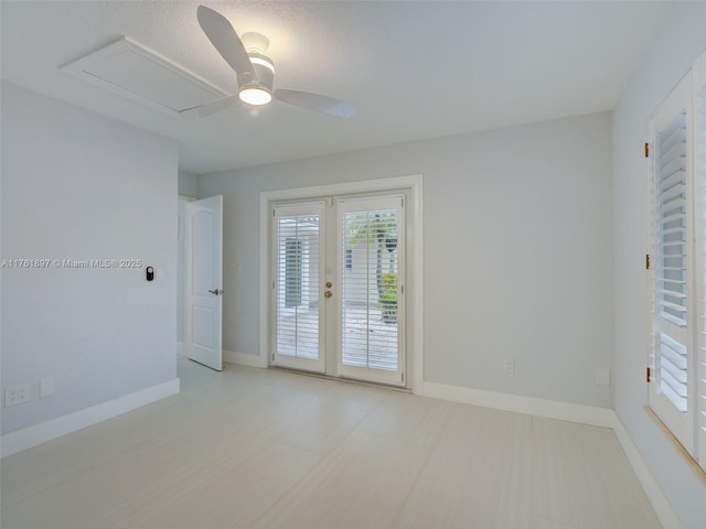 empty room featuring french doors, a ceiling fan, and baseboards