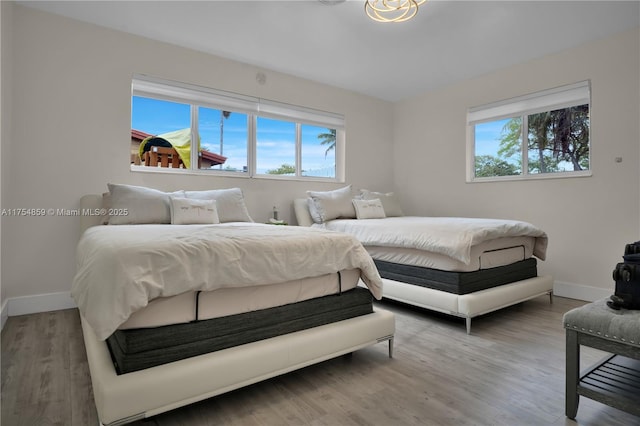 bedroom featuring wood finished floors and baseboards