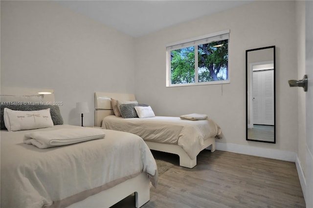 bedroom with wood finished floors and baseboards