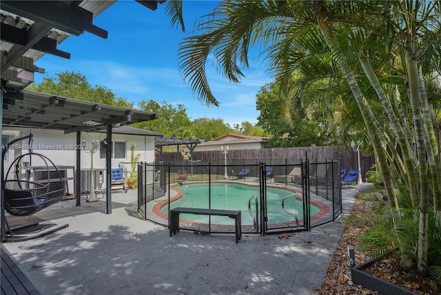 view of swimming pool with central AC unit, a fenced in pool, a patio, and a fenced backyard