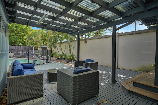 wooden deck with a fenced in pool, an outdoor hangout area, and a fenced backyard