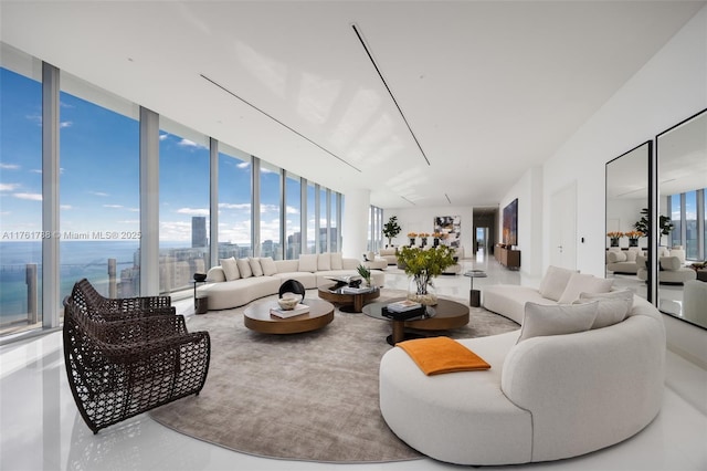 living room featuring finished concrete floors, a city view, and expansive windows