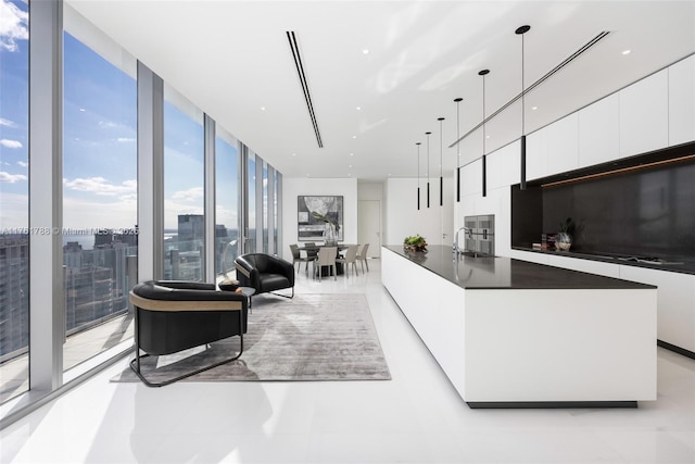 living room with a wall of windows and a city view