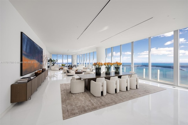 living area with a water view and expansive windows