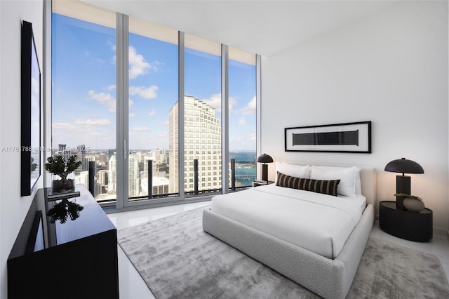 bedroom featuring a city view and expansive windows