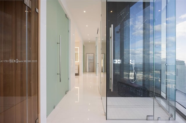 hallway with tile patterned flooring