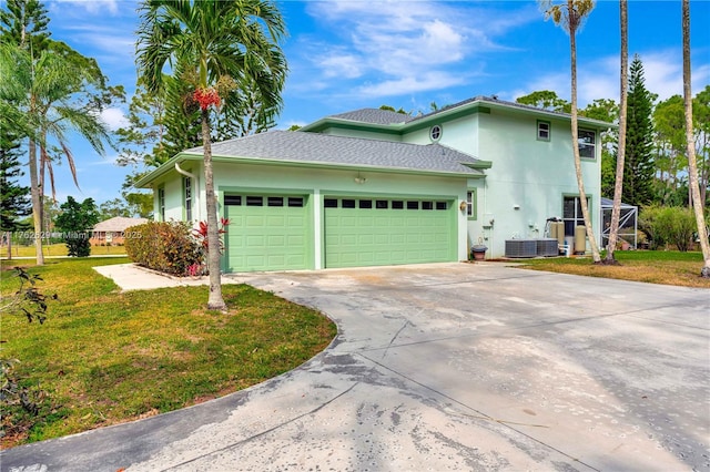 view of side of home featuring stucco siding, driveway, a yard, and an attached garage