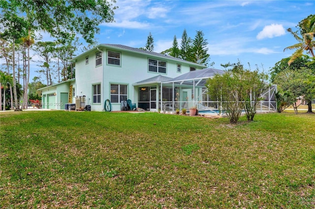 back of property with a garage, a lawn, glass enclosure, and stucco siding