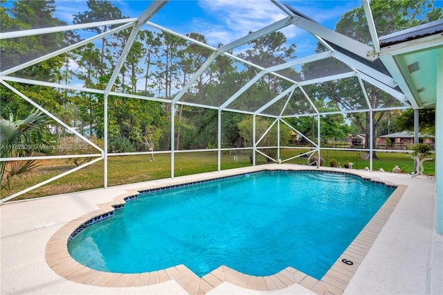 pool with a lanai, a patio area, and a yard