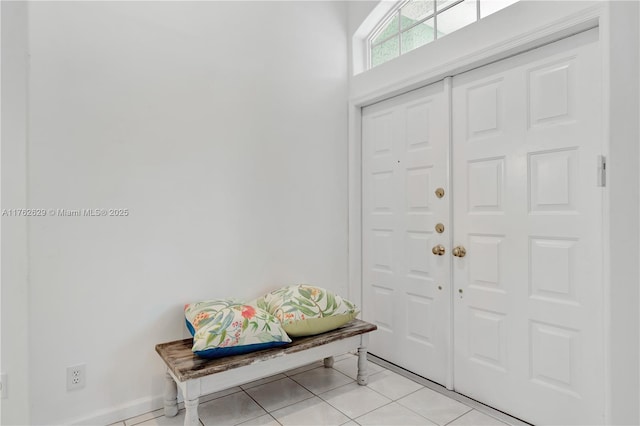 entrance foyer featuring light tile patterned floors and baseboards