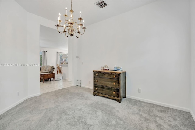 carpeted empty room featuring visible vents, baseboards, a notable chandelier, and tile patterned flooring