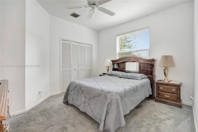 bedroom with visible vents, baseboards, light colored carpet, a closet, and a ceiling fan