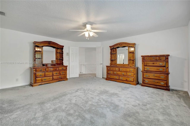 bedroom with ceiling fan, carpet, baseboards, and a textured ceiling