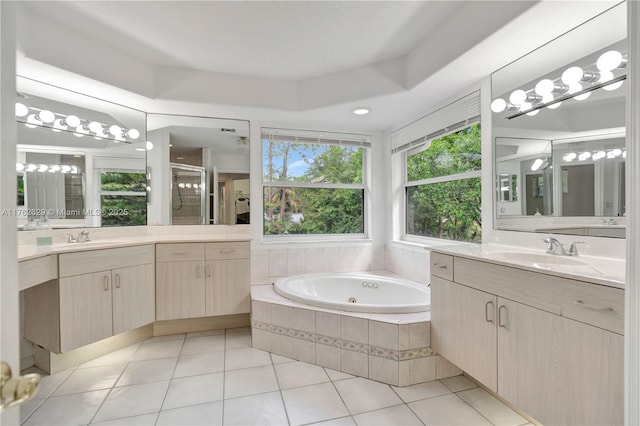 bathroom featuring a bath, tile patterned floors, a stall shower, and a sink