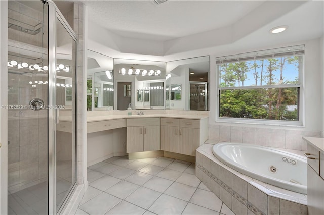 bathroom featuring a jetted tub, a stall shower, vanity, and tile patterned flooring