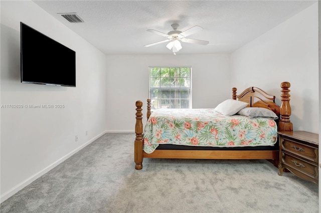 carpeted bedroom featuring visible vents, baseboards, a textured ceiling, and a ceiling fan